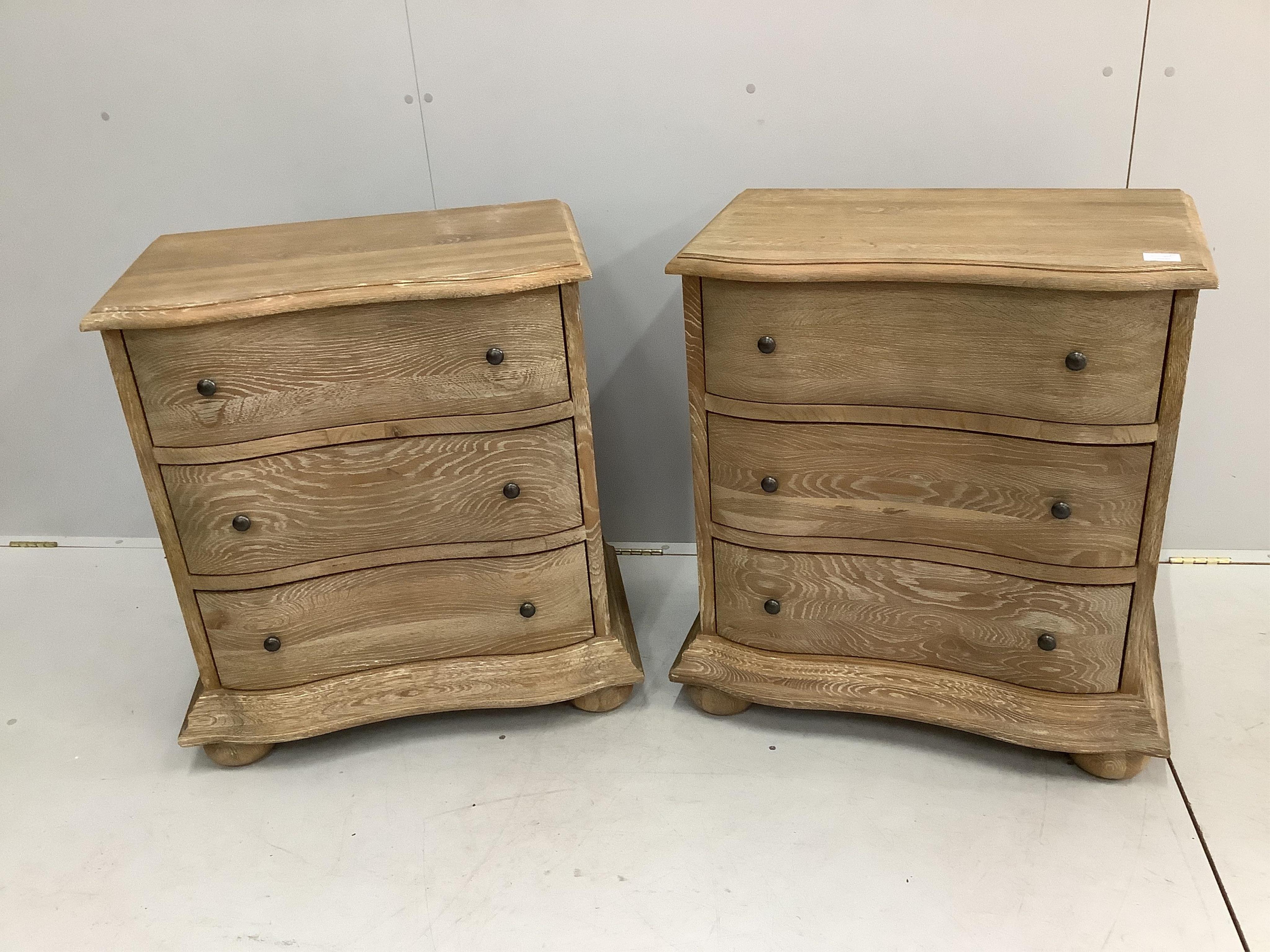 A pair of modern Feather & Black 'Blenheim' limed oak bedside chests of three drawers, width 68cm, depth 41cm, height 77cm. Condition - good